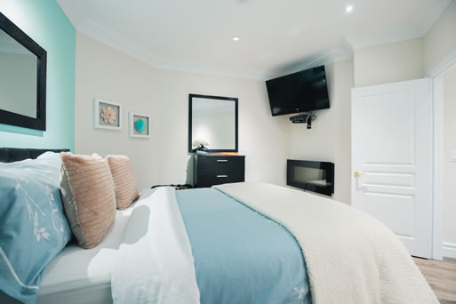 Merrydale Suite - Basement level. Features queen bed, den, shower, fridge, smart TV, kitchenette and living room/dining area.  $293.80 incl. H.S.T. (minimum 2 night stay) (3 persons)